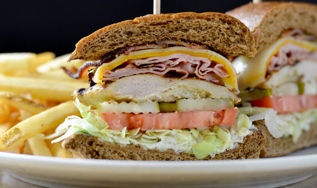 Grilled Chicken Club · Mesquite grilled chicken, wheat bun, ham, bacon, cheddar and jack, lettuce, tomato, pickle, mayo, choice of side item