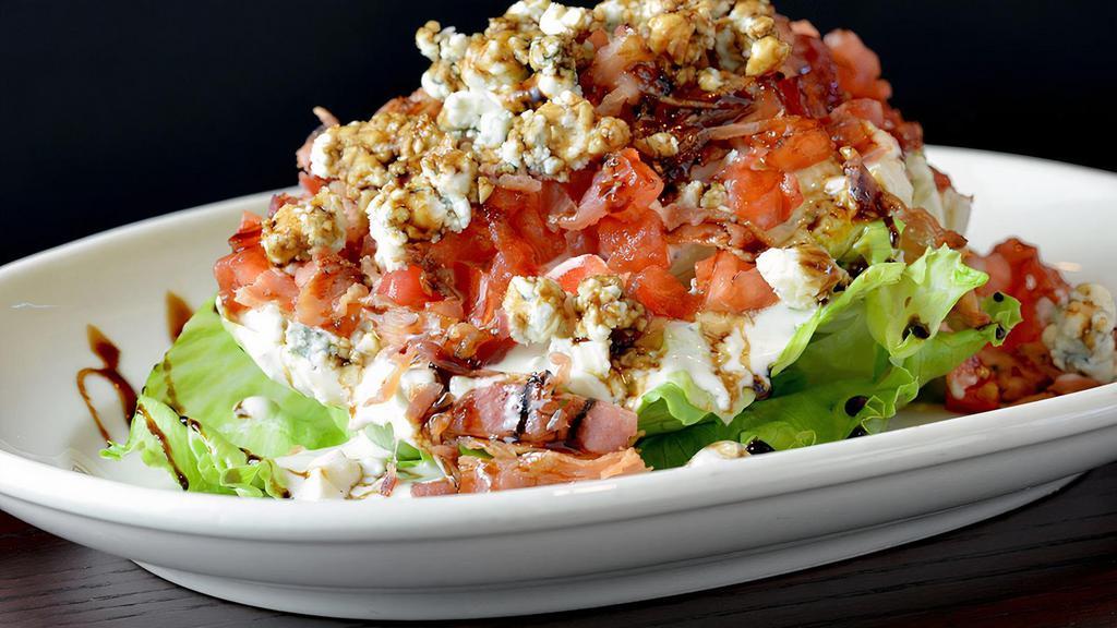 Wedge Salad · Baby iceberg, crumbled blue cheese, diced tomato, bacon, sweet red wine reduction, blue cheese dressing on the side