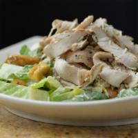 Grilled Chicken Caesar Salad · Chilled & sliced grilled chicken, romaine, croutons, parmesan, eggless Caesar dressing on th...