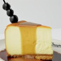 New York Style Cheesecake · New York Style Cheesecake topped with bourbon caramel sauce and Luxardo cherries
