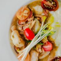 Local Shrimp N Grits · Sawmill gravy, tasso ham, andouille, crispy shallots, Canewater Farms Organic Grits.