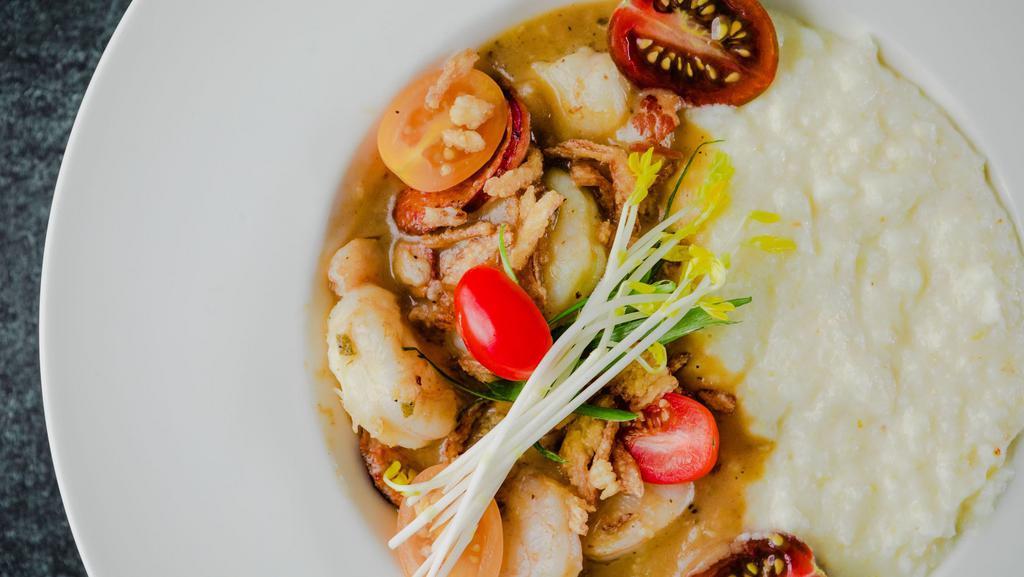 Local Shrimp N Grits · Sawmill gravy, tasso ham, andouille, crispy shallots, Canewater Farms Organic Grits.