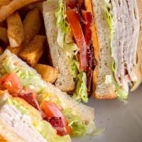 Turkey Club · 1070 Cal. Slow-roasted turkey breast, hickory-smoked bacon, American and Swiss cheeses on gr...