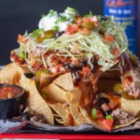 Bbq Pork Nachos · Homemade chips topped with creamy queso, lettuce, tomatoes, black olives, jalapeño peppers, ...