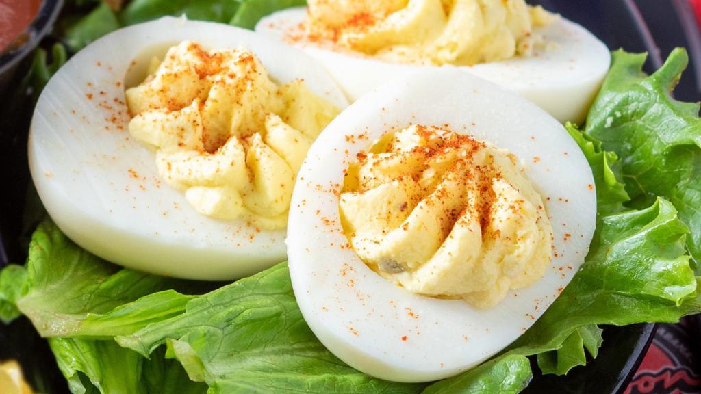 Deviled Eggs · Three halves of our southern-stye stuffed eggs.