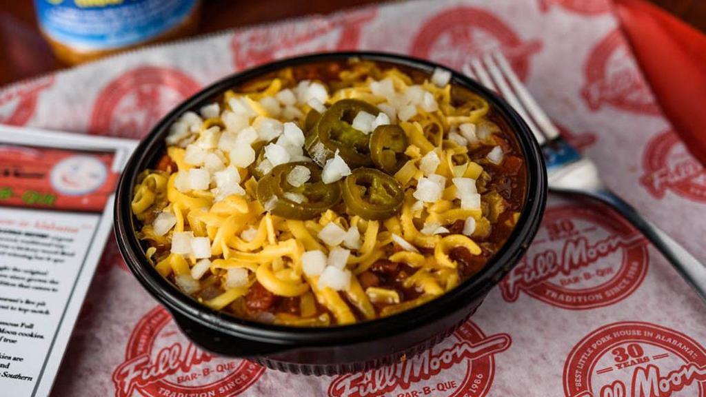 Homemade Chili · Chili is topped with cheddar cheese, diced onions and jalapeños.