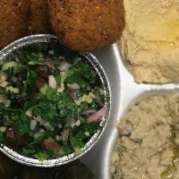 Vegetarian Delight Plate · Served with a generous portion of hummus, baba ghanouj, tabouleh salad. Three grape leaves, ...