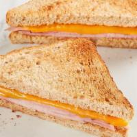 Kids Ham Toastie  · American cheese with ham on toasted wheat bread. Comes with your choice of a side and a Mini...