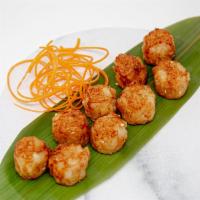 Shrimp Shumai · Mini shrimp shumai dumplings, served with sauce.