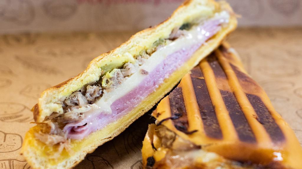 Cuban Sandwich · Cuban sandwich on Cuban bread with ham, pork, and Swiss cheese.
