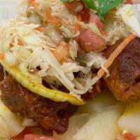 Chancho Con Yuca · Chunks of marinated fried pork served with broil cassava and fresh cabbage salad.