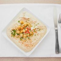 Hummus (V&Gf) · Cooked chickpeas, mixed with tahini sauce, lemon juice and spices, served with 1 pita bread.