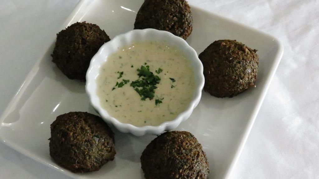 Falafel (V&Gf) · 5 golden brown pieces of homemade felafel made with ground chickpeas, spices and herbs, served with tahini sauce.