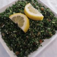 Tabbouleh Salad (V) · A mix of chopped parsley, tomato, onion, bulgar, spices, herbs, lemon juice and olive oil.
