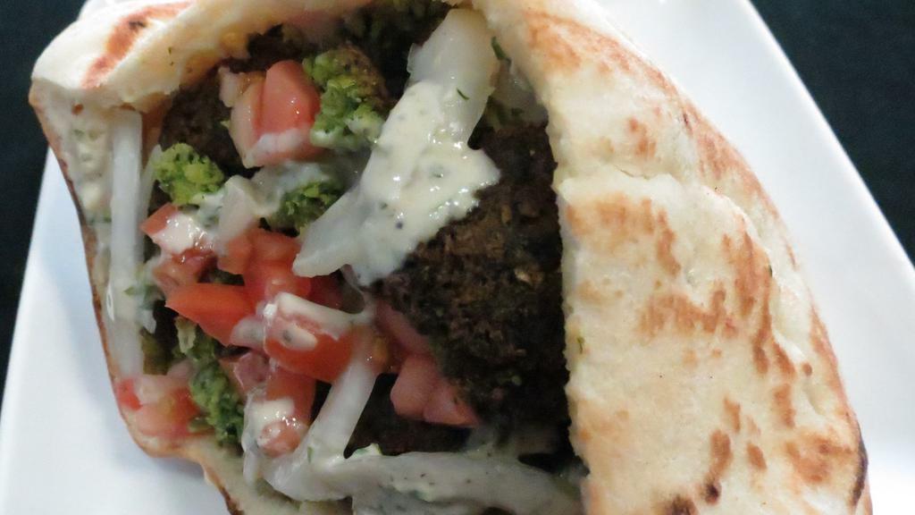 Falafel Sandwich (V) · Falafel, hummus, tabbouleh, lettuce, tomato, onion and tahini sauce.