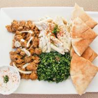 Chicken Shawarma Plate · Broiled and spiced chicken served on a bed of pita and hummus. Served garlic sauce, turnips,...