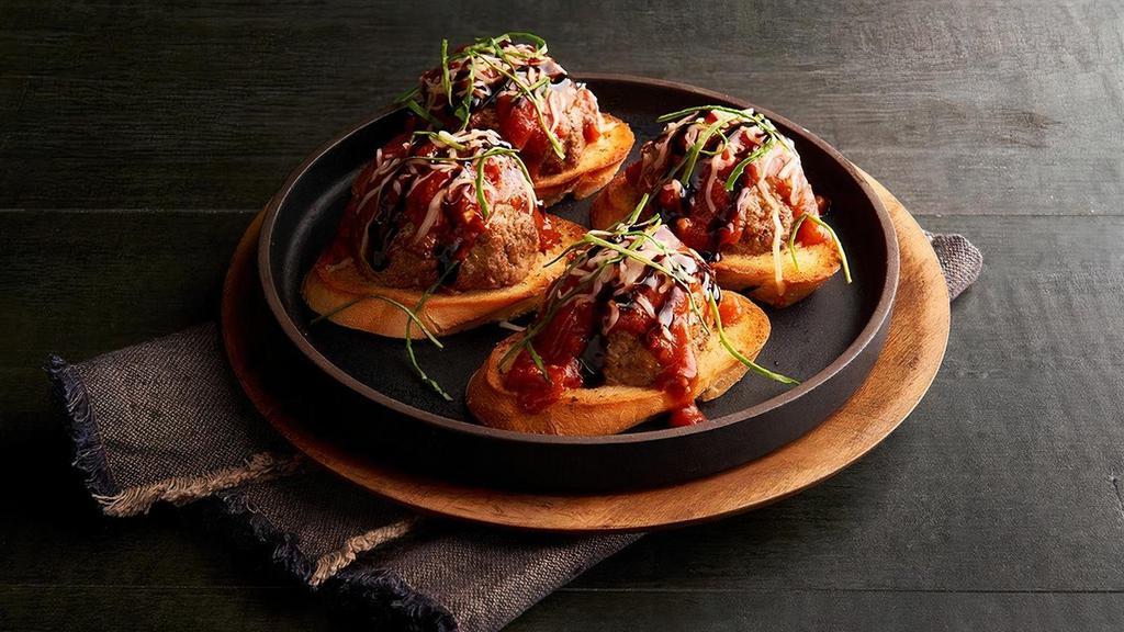 Mama’S Meatball Crostini · Our very own Italian style meatballs made with beef, pork, herbs, ricotta and Romano cheeses served on crispy, garlic buttered toasted bread topped with flavorful marinara sauce, a blend of cheeses, fresh basil, then drizzled with balsamic glaze.