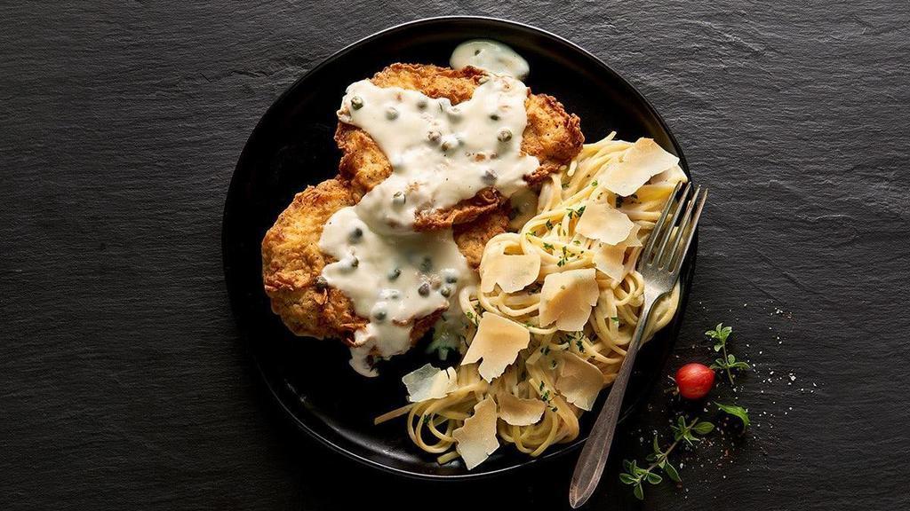 You Gotta Chicken Piccata · Two lightly battered, lightly fried chicken breasts topped with an Alfredo and white wine and lemon sauce with some tangy capers mingled in. This tasty little number is served with a side of linguini tossed in Alfredo sauce, sprinkled with shaved parmesan.