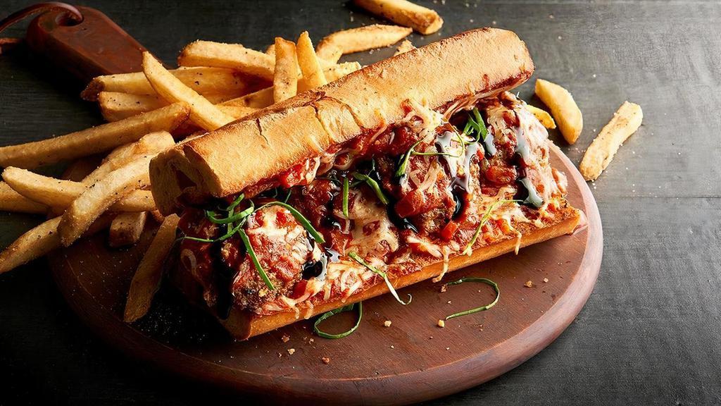 The Maestro’S Meatball Sub · Nobody makes a meatball sub like Mr. Mandrino. Our delicious meatballs made with beef, pork, herbs, ricotta and Romano cheeses tossed in our flavorful marinara sauce, served on a crunchy, toasted garlic-buttered baguette with our melted cheese blend. It’s then sprinkled with fresh basil, drizzled with balsamic glaze and served with hot, seasoned fries.