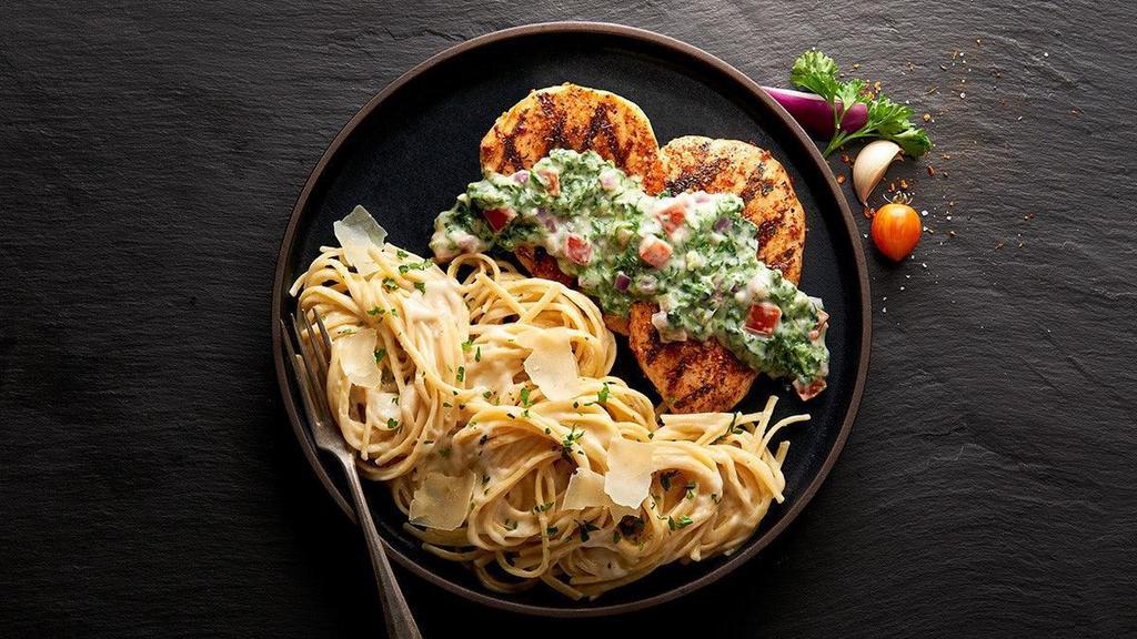 Chicken Tuscany · Two tender grilled chicken breasts seasoned the Italian way… with aromatic herbs, covered with a blend of Alfredo sauce, spinach, tomatoes, onion and garlic. All served with a side of linguini tossed in Alfredo sauce, sprinkled with parmesan cheese.