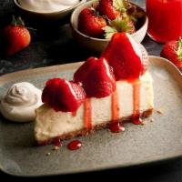 Strawberry Cheesecake · Creamy, New York style cheesecake adorned with fresh strawberries and a strawberry sauce. Se...