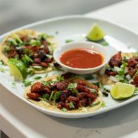 Tacos · Small hand-sized corn tortilla filled with your choice of meat and topped with cilantro and ...
