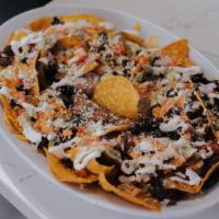Nachos · Tortilla chips topped with your choice of meat, cheese sauce, pico de gallo and sour cream.
