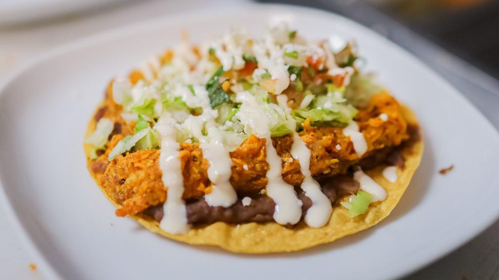 Tostadas · Flat corn tortilla deep-fried with fried & Choice of Protein, topped with beans, lettuce, tomato, cheese and sour cream.
