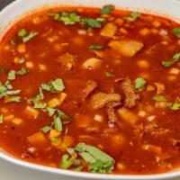 Menudo · Cow stomach in broth with a red chili pepper base.