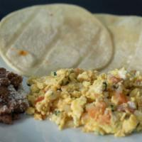 Huevos A La Mexicana · Eggs Mexican style scrambled eggs, cooked in a sauce of tomatoes, onions, and jalapeño pepper.