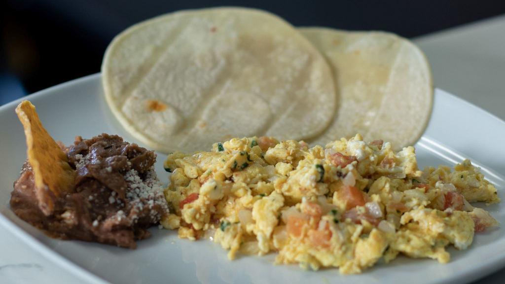 Huevos A La Mexicana · Eggs Mexican style scrambled eggs, cooked in a sauce of tomatoes, onions, and jalapeño pepper.