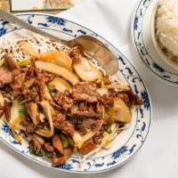 Mongolian Beef · Sliced tender beef sauteed with onion, garnished with rice noodle.