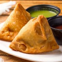 Samosa - Veg  (2Pc) · A samosa is a fried pastry with a savoury filling, such as spiced potatoes, onions, peas,tri...