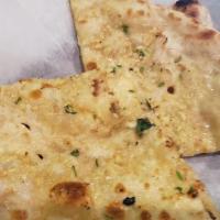 Chili Garlic Naan · Butter naan spiced with chilies and cilantro.
