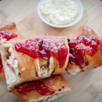 Cheesecake Stromboli · A slice of New York-styled cheesecake wrapped in dough with your choice of flavor sauce!