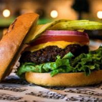 The American Standard Burger · American Cheese, Chopped Romaine, Tomato, Red Onion, and Pickle Planks on a Brioche Bun