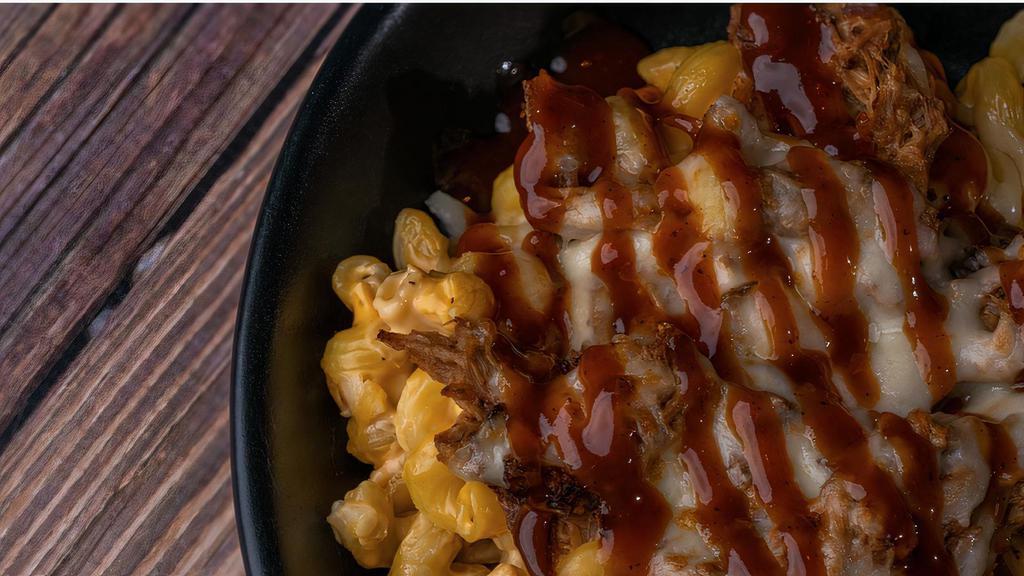 Pulled Pork Mac N'Cheese · Bourbon bbq pulled pork and cavatappi pasta, tossed in our ford's beer cheese blend, topped with a shredded Muenster cheese blend