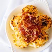 Gnocchi Alla Romana · House-made semolina gnocchi with Grana Padano cheese and crispy prosciutto