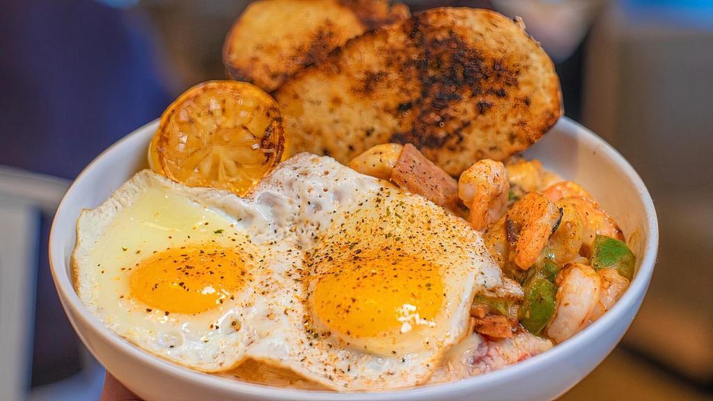 Shrimp & Grits Bowl · Sautéed shrimp, andouille sausage, green peppers, sautéed onions and Swiss cheese, on top of fire-roasted tomato and spinach grits.  Topped with two eggs and served with garlic toast.