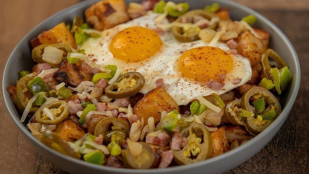 Southwestern · Home fries topped with ham, jalapenos, onions, peppers, pepper jack cheese and two eggs with a side of salsa and sour cream.