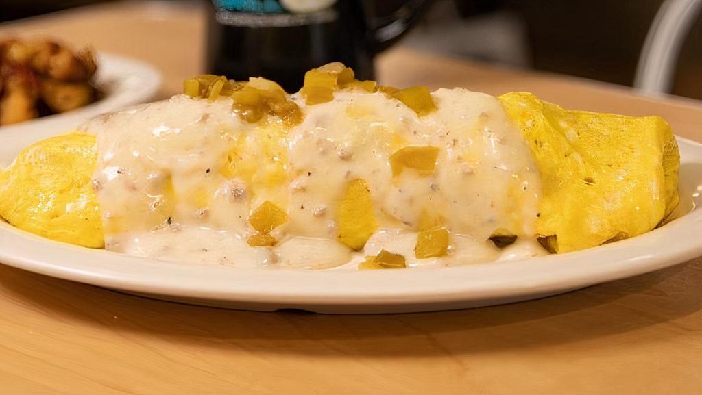 Texas Farm House Omelet · A four-egg omelet loaded with bacon, andouille sausage, mushrooms, home fries, pepper jack cheese, pickled jalapenos and green chiles, topped with sausage gravy and hatch chiles, and served with a choice home fries or grits and toast