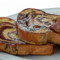 Cinnamon Swirl French Toast · Two slices of our famous cinnamon swirl bread dipped in custard, sautéed and sprinkled with ...