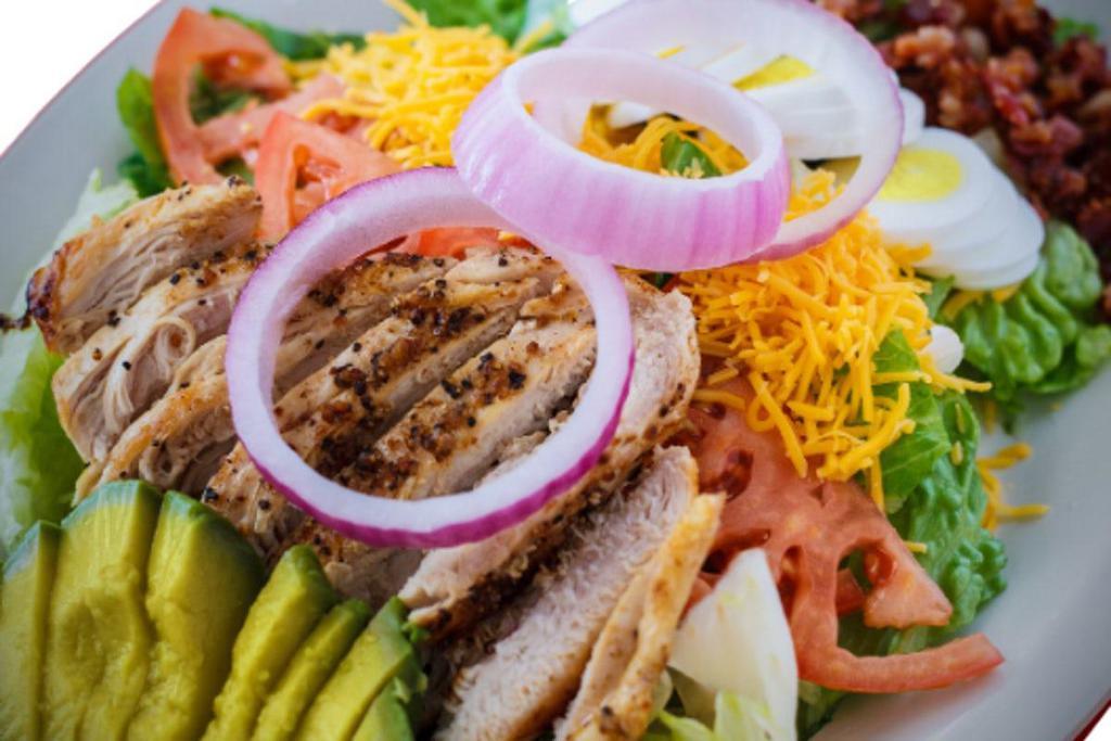 Cobb Salad · Mixed greens, bacon, avocado, red onions, tomato, boiled egg, grilled chicken breast, and cheddar cheese.