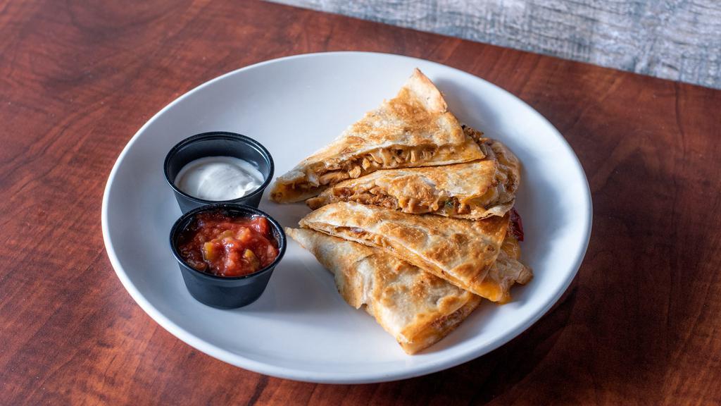 Chicken Quesadilla · Grilled flour tortilla, fajita spiced chicken, caramelized onions, red peppers, cheese, sour cream, salsa, and guacamole.