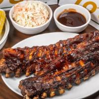 Baby Back Ribs - Full Rack · Slow roasted and flame-grilled, Jack Daniel's BBQ sauce, served with choice of 2 sides.