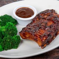Baby Back Ribs - 1/2 Rack · Slow roasted and flame-grilled, Jack Daniel's BBQ sauce, served with choice of 2 sides.