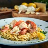 Shrimp Scampi · Jumbo shrimp, angel hair spaghetti, white wine garlic butter, aged parmesan, served with gar...