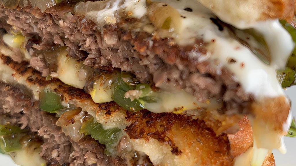 Philly Cheese Patty Melt · Seasoned and grilled Impossible patty, sautéed peppers and onions, Violife mozzarella, mayo, mustard, buttery toasted artisan bread. Peppers and onions on sandwich are mixed and cannot be separated. Comes w- our house fries.
