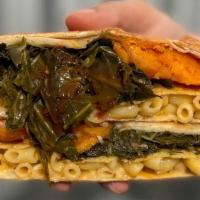 Soul Food Crunchwrap · A unique favorite! Baked macaroni and cheese, slow cooked collard greens topped with hot sau...