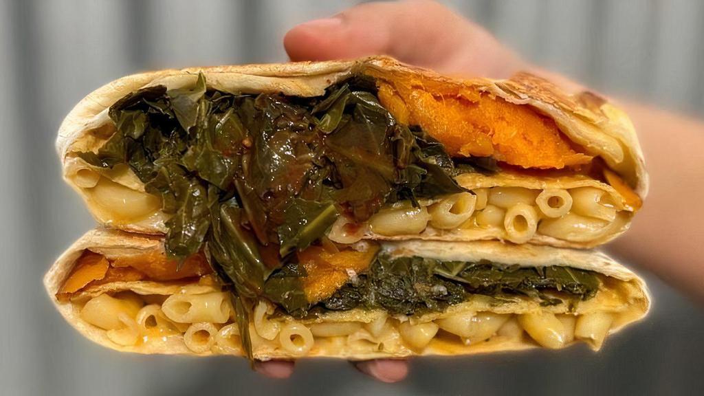 Soul Food Crunchwrap · A unique favorite! Baked macaroni and cheese, slow cooked collard greens topped with hot sauce, and candied yams joined together with a crunchy corn tostada, wrapped in a flour tortilla, and toasted on our flat top.